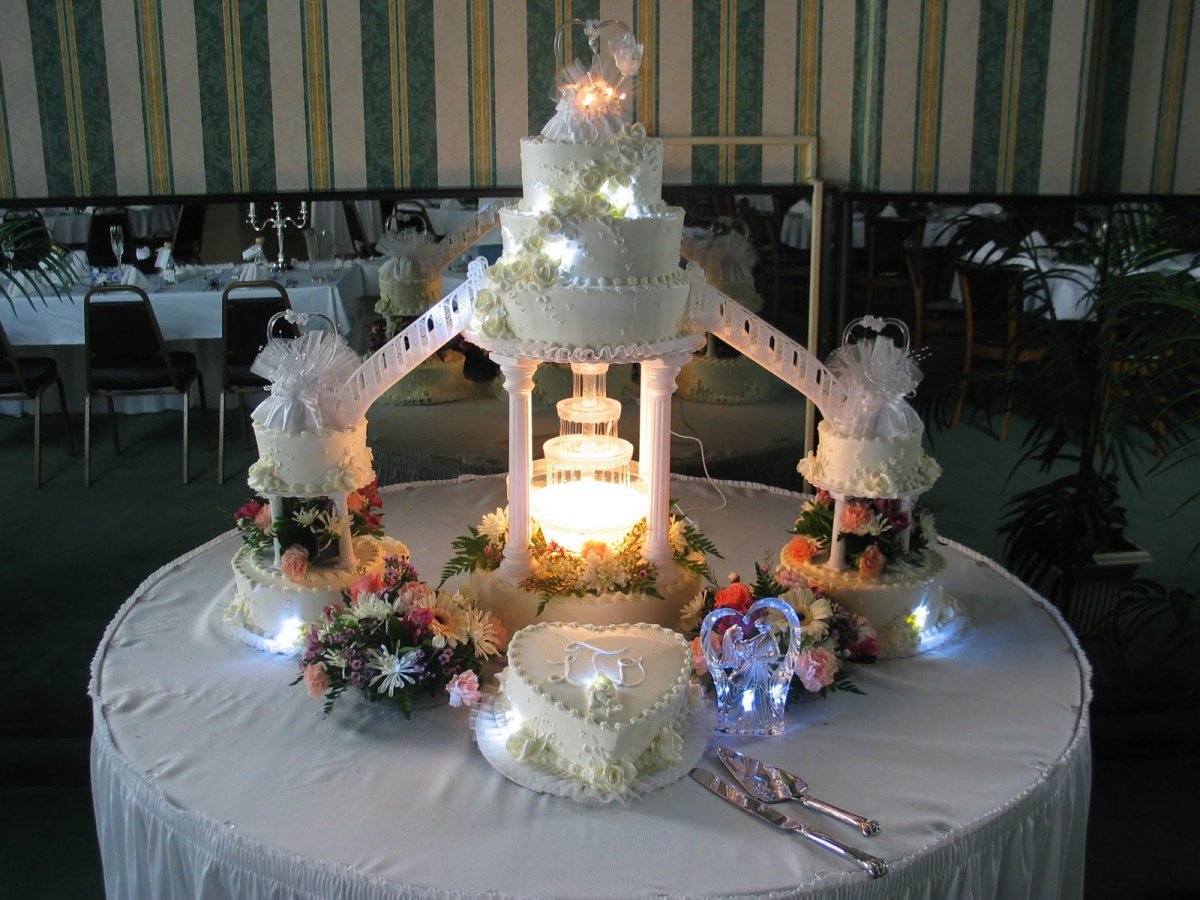 The Wedding Cake is Cut by the Newlyweds