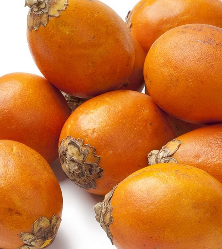 Желтые фрукты названия. Оранжевый фрукт похожий на фейхоа. Желтый Южный фрукт. Оранжевый экзотический фрукт. Фрукт оранжевый с косточками.